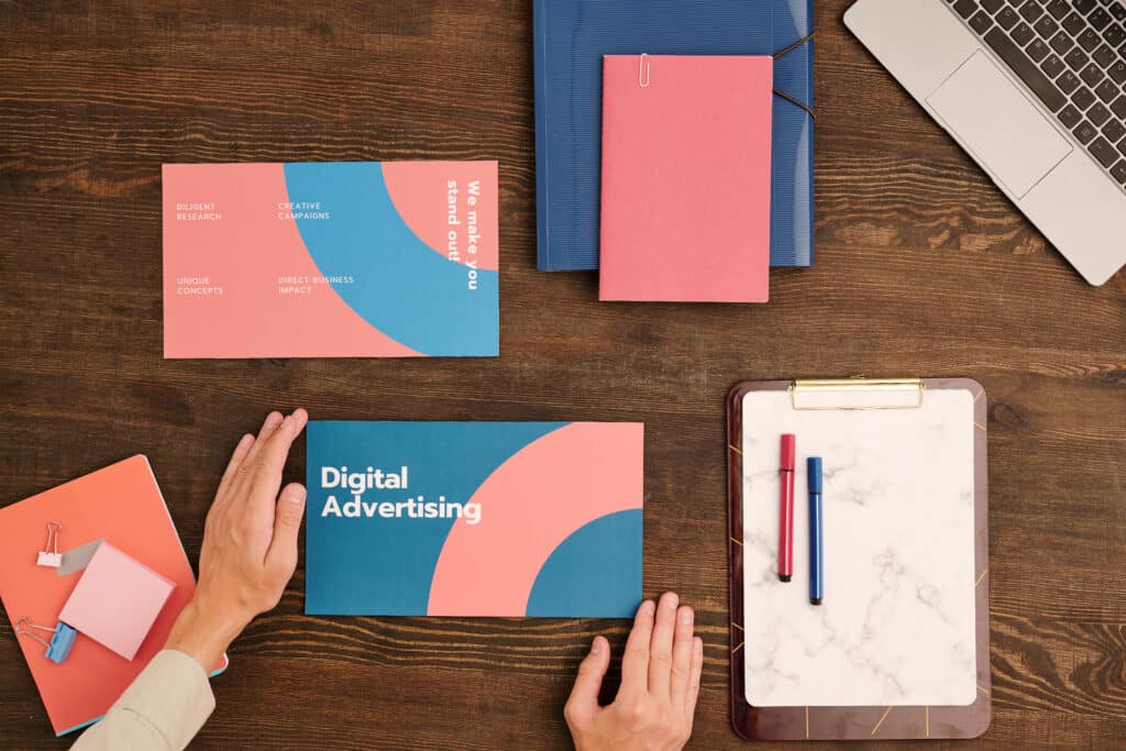Overview of hands of contemporary male business coach holding folder with digital advertising paper materials while going to start training