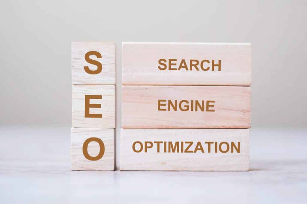 SEO explained concept (Search Engine Optimization) text wooden cube blocks on table background. Idea, Vision, Strategy, Analysis, Keyword and Content concept