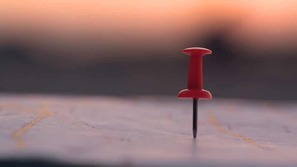 local city SEO concept with a red push pin in a map