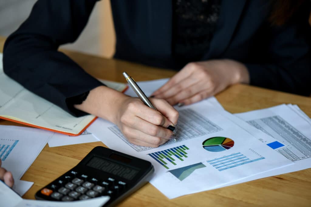 Office staff analyze marketing data on the office desk in the office.