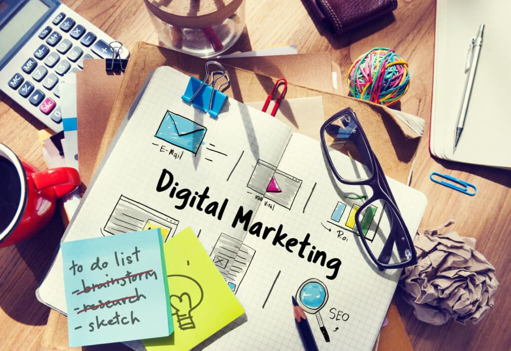 Digital Marketing concept with a digital marketing agency desk with various items on it